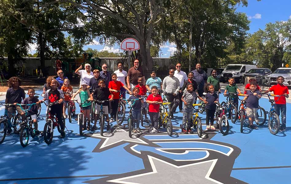 Kissimmee Bike Giveaway Brings Smiles to 40 Kiddos in Afterschool Program Celebration
